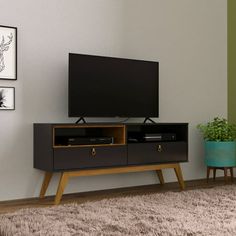 a flat screen tv sitting on top of a wooden stand in front of a wall