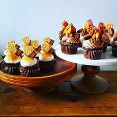 several cupcakes with marshmallows on them are sitting on a cake stand