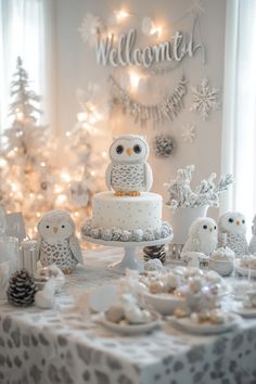 an owl cake sits on top of a table surrounded by small owls and pine cones