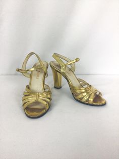 "Vintage 1990s gold lame leather strappy sandal Gold Lame high heel Leather sole Strap wraps around back ankle and buckles Toe box made up of 5 straps that \"gather\" in the center with a single strip of gold leather MEASUREMENTS: Marked US 6/EU 36.5/ Asia 22 Insole: 9.25\" Ball: 2 7/8\" Heel: 3 7/8\" Brand/Label: Carlos Sanchez Made in Italy Condition: Excellent * natural wear on sole and some light wear to gold lame on heels (See pic)" Vintage Gold Sandals For Evening, Vintage Gold Sandals For Formal Occasions, Vintage Gold Heels With 4-inch Heel, Retro Gold Heels For Party, Vintage Gold Heels For Summer, Vintage Gold Sandals With Round Toe, Vintage Ankle Strap Sandals For Party, Vintage Gold Ankle Strap Heels, Retro Gold Open Toe Heels