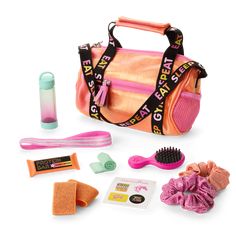 a pink and orange bag with various items in it including hair brush, toothpaste, comb, gloves, and other accessories