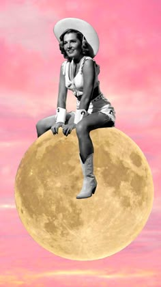 a woman sitting on top of a giant moon