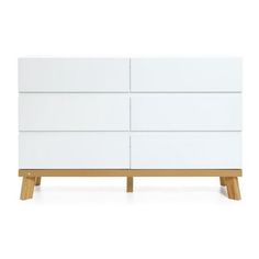 a white dresser with wooden legs and drawers