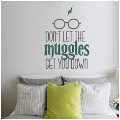 a bedroom with a wall decal that says don't let the muggles get you down