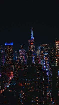 the city skyline is lit up at night with bright lights and skyscrapers in the background