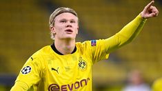 a young man in a yellow uniform is playing soccer