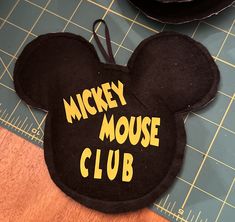 the mickey mouse club hat is on top of a cutting board