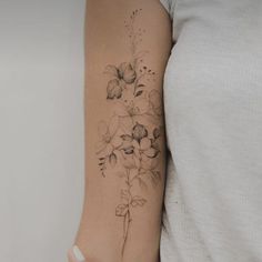 a woman with a flower tattoo on her arm