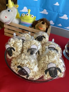 some kind of food on a table with stuffed animals and other toys in the background