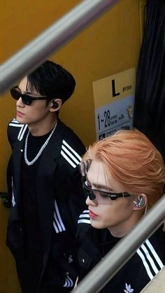 two male mannequins wearing sunglasses and black clothing