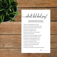 a printable what did dad say? card on top of a wooden table next to a potted plant