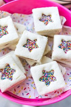 small white cakes with sprinkles in a pink bowl