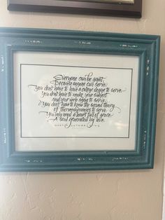 a framed poem hanging on the wall next to a toilet paper dispenser