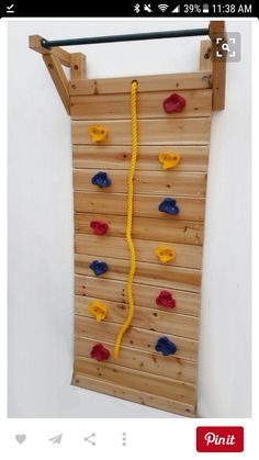 a climbing wall made out of wooden boards with ropes attached to the top and bottom