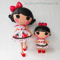 two dolls that are standing next to each other