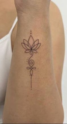 a woman's arm with a tattoo on it and a flower in the middle