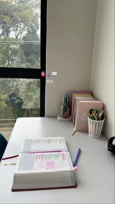 an open book sitting on top of a white desk