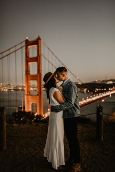 a couple embracing in front of the golden gate bridge