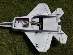 an airplane is laying on the grass with wires attached to it's wings and propellers