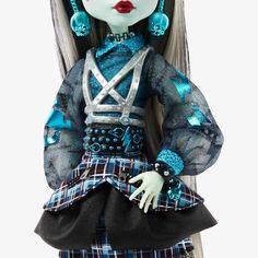 a doll with white hair and blue eyes is wearing a plaid skirt, black shirt and turquoise earrings