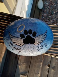 a painted rock with a dog's paw on it