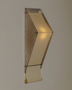 a wall mounted light fixture on the side of a wall