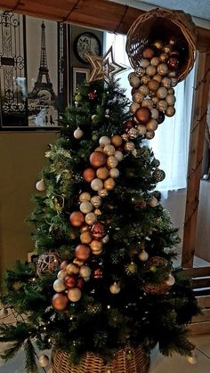 a christmas tree decorated with ornaments in a basket