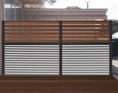 a wooden bench sitting in front of a building