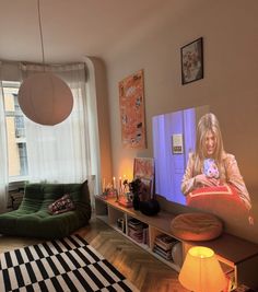 a living room filled with furniture and a flat screen tv mounted to the side of a wall