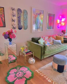 a living room filled with lots of furniture and colorful art on the wall above it