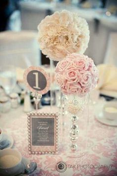 the table is set with flowers and place cards