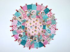 a pink and blue patchwork circle with mickey mouses on it