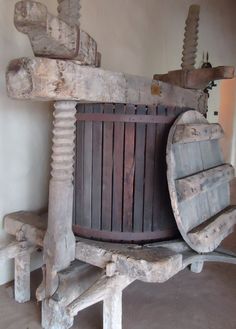 an old wooden barrel sitting on top of a bench