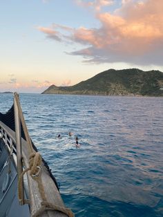 two people swimming in the ocean on a boat