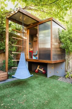 an outdoor play area with a swing set and wooden structure in the middle of it