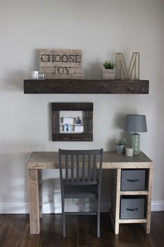 a desk with two chairs and a shelf above it that says choose joy on the wall