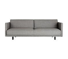 a gray couch sitting on top of a white floor