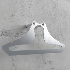 a pair of metal scissors hanging on the side of a wall