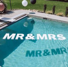 a pool with the words mr and mrs written on it in front of some balloons