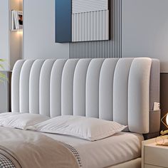 a bed with white sheets and pillows in a room