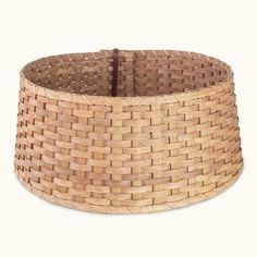 a large woven basket is shown on a white background with a brown leather strap around it