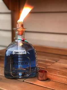 a blue bottle sitting on top of a wooden table