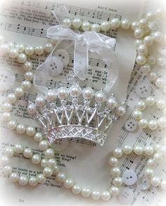 a tiara and pearls on sheet music