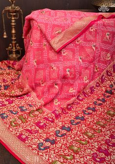 This magnificent Authentic Hand Bandhej on Meenakari Shikargah Banarasi Silk Georgette Saree in Peach is a striking fusion of artforms. Indian craftsmanship combine to form a beautiful and lively piece, guaranteed to spark joy. Its vivid border and body are adorned with Georgetti Meenakari Shikargah motifs, complemented by the delicate Bandhni work of Gujarat. The wide skirt border and intricate Sarkam bandhej work add to the exquisiteness of the product! SILK MARK CERTIFIEDThis saree is ready t Semi-stitched Paithani Silk Sets With Motifs, Unstitched Meenakari Sharara, Designer Red Paithani Silk Pre-draped Saree, Semi-stitched Sharara With Motifs, Designer Wear Lehenga With Motifs, Jamawar Anarkali Set For Navratri, Brocade Sharara With Pallu, Banarasi Silk Sharara With Cutdana, Brocade Sharara For Festivals