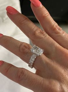 a woman's hand with a diamond ring on it