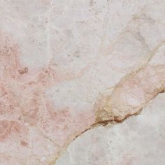 a close up view of a marble surface with pink and white paint on the edges