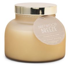 a glass jar with a label that says driftwood breeze on the front and side