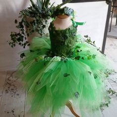 a green tutule dress sitting on top of a mannequin