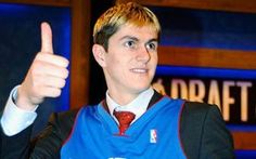 a man in a detroit basketball jersey giving a thumbs up