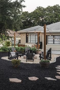 an outdoor patio with chairs and lights on the roof, surrounded by graveled walkways